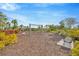 Community playground with swings, slide, bench, and lush landscaping, offering a fun and safe outdoor space for residents at 4831 Rosatti Rd, Wesley Chapel, FL 33543