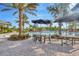 Relaxing pool patio area with outdoor seating, tables, and umbrellas at 4831 Rosatti Rd, Wesley Chapel, FL 33543