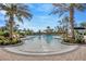 Resort-style pool with palm trees, lounge chairs, and umbrellas for relaxing in luxury at 4831 Rosatti Rd, Wesley Chapel, FL 33543
