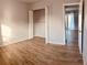 This bedroom has wood-look tile floors, light grey walls and a closet with sliding doors at 4872 Beach Se Dr # D, St Petersburg, FL 33705