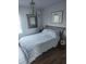 Cozy bedroom featuring natural lighting, wood-look flooring, and a unique chandelier for added elegance at 4872 Beach Se Dr # D, St Petersburg, FL 33705