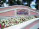Entrance to the Waterside community with vibrant flowerbeds and manicured landscaping at 4872 Beach Se Dr # D, St Petersburg, FL 33705