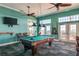 Spacious game room featuring a pool table, ceiling fans, and ample natural light with water views at 4872 Beach Se Dr # D, St Petersburg, FL 33705