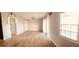 Spacious living room featuring light grey walls and wood-look tile floors throughout the home at 4872 Beach Se Dr # D, St Petersburg, FL 33705