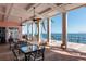 Inviting outdoor seating area with ceiling fans overlooking the waterfront and a private pier at 4872 Beach Se Dr # D, St Petersburg, FL 33705