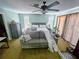 Cozy bedroom with ceiling fan, large windows, and plenty of space for relaxation at 5012 Ensign Loop, New Port Richey, FL 34652
