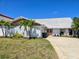 Charming single Gathering home featuring a stone facade and a well-maintained front yard with palm trees at 5012 Ensign Loop, New Port Richey, FL 34652