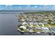 Expansive aerial view showcasing a waterfront property and its surroundings on a sunny day at 5193 Boyle Ter, Port Charlotte, FL 33981