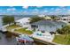 Rear exterior featuring waterfront views, patio with seating, boat lift, and well-maintained yard at 5193 Boyle Ter, Port Charlotte, FL 33981