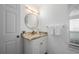 Bright bathroom featuring a modern vanity, round mirror, and stylish fixtures at 5193 Boyle Ter, Port Charlotte, FL 33981