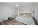 Well-lit bedroom featuring hardwood floors and a cozy bunk bed with modern ceiling fan at 5193 Boyle Ter, Port Charlotte, FL 33981
