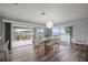Dining area features stylish modern chairs, an elegant chandelier, and a slider to the terrace at 5193 Boyle Ter, Port Charlotte, FL 33981