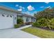 Exterior view of a single-story home, showcasing manicured landscaping and neutral paint at 5193 Boyle Ter, Port Charlotte, FL 33981