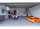 Spacious garage featuring an air hockey table, two kayaks, and epoxy flooring at 5193 Boyle Ter, Port Charlotte, FL 33981