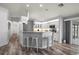 Well-lit kitchen showcases white cabinets, modern appliances, and a breakfast bar with seating at 5193 Boyle Ter, Port Charlotte, FL 33981