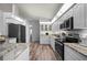 Modern kitchen with stainless steel appliances, white cabinets, and stylish countertops at 5193 Boyle Ter, Port Charlotte, FL 33981