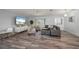 Bright living room with modern furniture and decor, laminate floors, and open layout at 5193 Boyle Ter, Port Charlotte, FL 33981