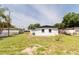 A well maintained backyard shows the property lines, and the back of the home at 5210 S 80Th St, Tampa, FL 33619