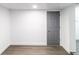 Spacious unfinished basement with gray door and wood-look floors at 5210 S 80Th St, Tampa, FL 33619