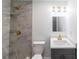 Modern bathroom with a tiled shower, sleek vanity, and stylish gold fixtures at 5210 S 80Th St, Tampa, FL 33619