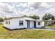 Well-maintained home with fresh white paint and gray trim, highlighted by a neatly kept lawn at 5210 S 80Th St, Tampa, FL 33619