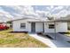 Charming white house featuring a covered entrance and well-manicured lawn at 5210 S 80Th St, Tampa, FL 33619