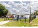 Charming home enclosed by a black metal fence, creating a secure and inviting atmosphere at 5210 S 80Th St, Tampa, FL 33619