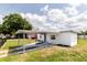 A view of home showcasing its covered driveway, clean exterior, and tidy landscaping at 5210 S 80Th St, Tampa, FL 33619