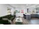 Open-concept living area with modern furniture and a view into the kitchen at 5210 S 80Th St, Tampa, FL 33619