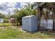 Backyard view of the gray shed with a light colored door at 5210 S 80Th St, Tampa, FL 33619