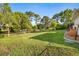 Spacious backyard featuring a well-manicured lawn and mature trees, perfect for outdoor enjoyment at 5296 Slater Rd, Spring Hill, FL 34608