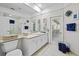 Bright bathroom with white cabinets, double sinks, and a door leading to the backyard at 5296 Slater Rd, Spring Hill, FL 34608