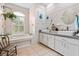 Bright bathroom with double sinks, a garden tub, and a large window letting in natural light at 5296 Slater Rd, Spring Hill, FL 34608