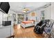 Sunlit bedroom with wood floors, a massage chair, and a slider leading to the backyard at 5296 Slater Rd, Spring Hill, FL 34608