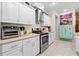 Modern kitchen with stainless steel appliances and white cabinetry at 5296 Slater Rd, Spring Hill, FL 34608