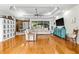 Spacious living room with hardwood floors, ceiling fan, and modern entertainment center at 5296 Slater Rd, Spring Hill, FL 34608