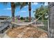 Backyard with a relaxing hammock area and views of the water, surrounded by lush landscaping and fencing at 5608 Skimmer Dr, Apollo Beach, FL 33572