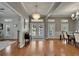 Elegant foyer featuring hardwood floors, modern lighting, and a welcoming atmosphere with double doors at 5608 Skimmer Dr, Apollo Beach, FL 33572
