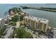 Aerial view of condo building with balconies, parking, and nearby beach access at 5701 Mariner St # 701, Tampa, FL 33609