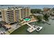 Aerial view of a waterfront condominium, boat dock, parking and beautiful landscaping at 5701 Mariner St # 701, Tampa, FL 33609