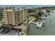 Bright aerial view of a waterfront condominium, boat dock, lush landscaping and water views at 5701 Mariner St # 701, Tampa, FL 33609