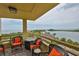 Balcony with orange cushioned chairs overlooks the ocean and bay at 5701 Mariner St # 701, Tampa, FL 33609