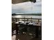 A dining table is set on the balcony overlooking the bay, ideal for outdoor meals at 5701 Mariner St # 701, Tampa, FL 33609