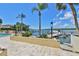 Beautiful waterfront view with a dock, boats, lush landscaping, and a blue sky at 5701 Mariner St # 701, Tampa, FL 33609