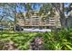View of the building featuring multiple balconies, parking, and beautiful landscaping at 5701 Mariner St # 701, Tampa, FL 33609