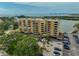 Elevated exterior view of a condominium building with parking and water views at 5701 Mariner St # 701, Tampa, FL 33609