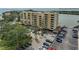 An exterior of the condo building showcasing a parking area and nearby waterway and some water views at 5701 Mariner St # 701, Tampa, FL 33609