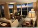 A view of the living room with furniture and access to the balcony overlooking the ocean at 5701 Mariner St # 701, Tampa, FL 33609