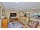 Open-concept living room with modern furniture connected to the kitchen with ocean views at 5701 Mariner St # 701, Tampa, FL 33609