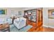 Living room features hardwood floors and a built-in bookcase, blending comfort and convenience at 5701 Mariner St # 701, Tampa, FL 33609
